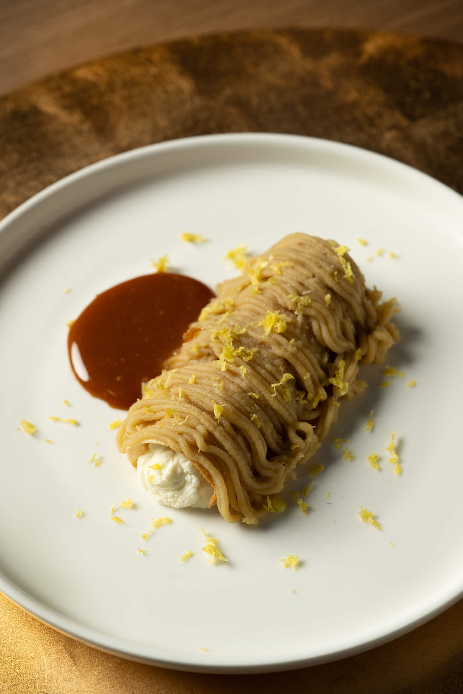 Wagyu dish with sauce and lemon zest